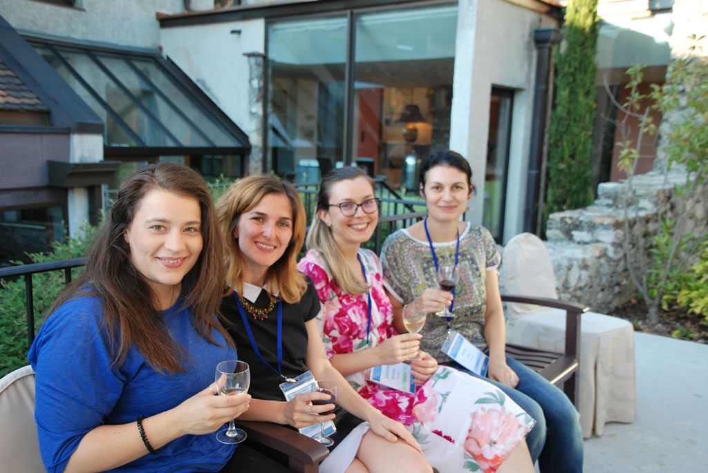 Young Investigators at a recent Summer School, sitting on a bench