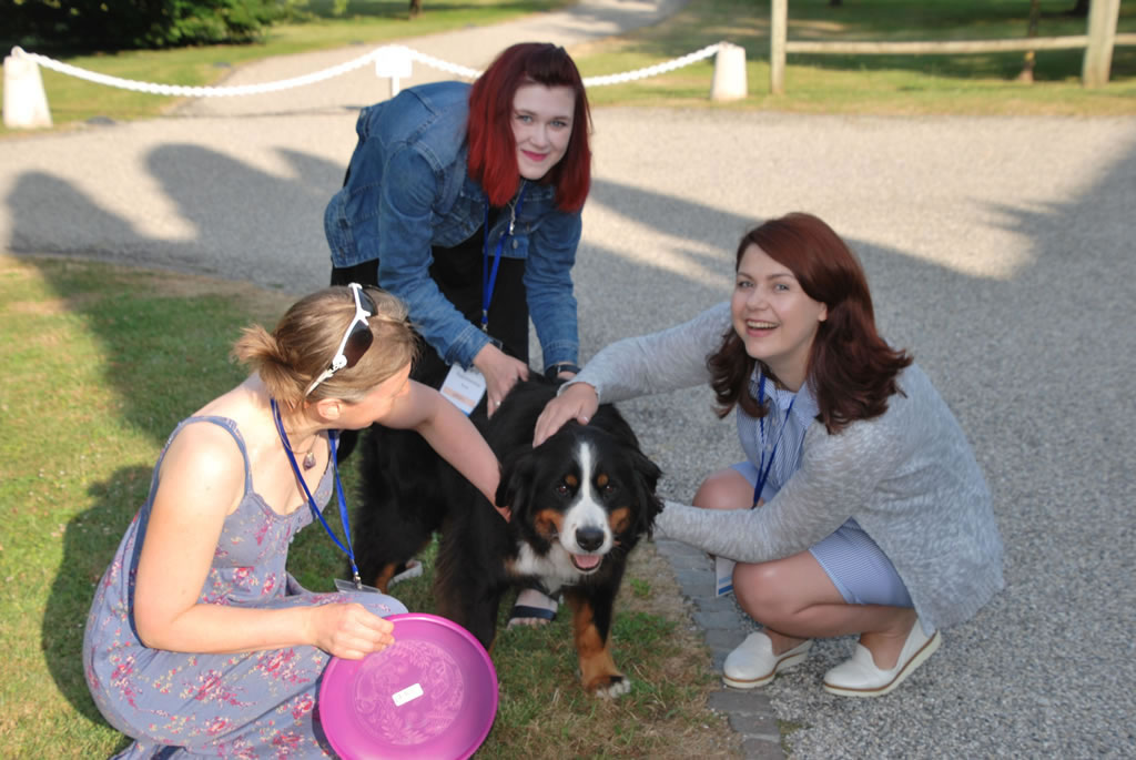 Young Investigators at a recent Summer School take part in outdoor activities with a canine companion