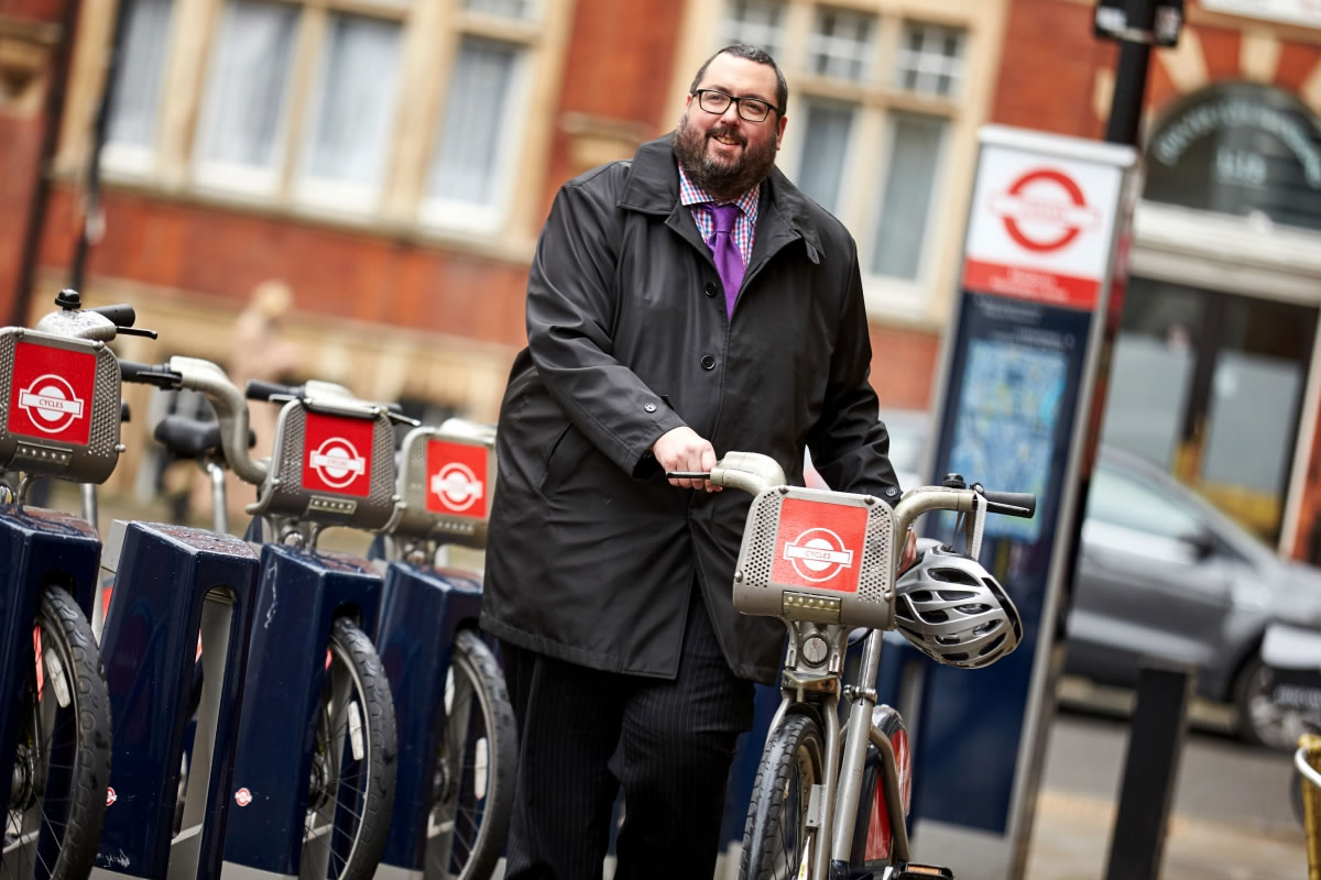 A man with a bicycle on a London street