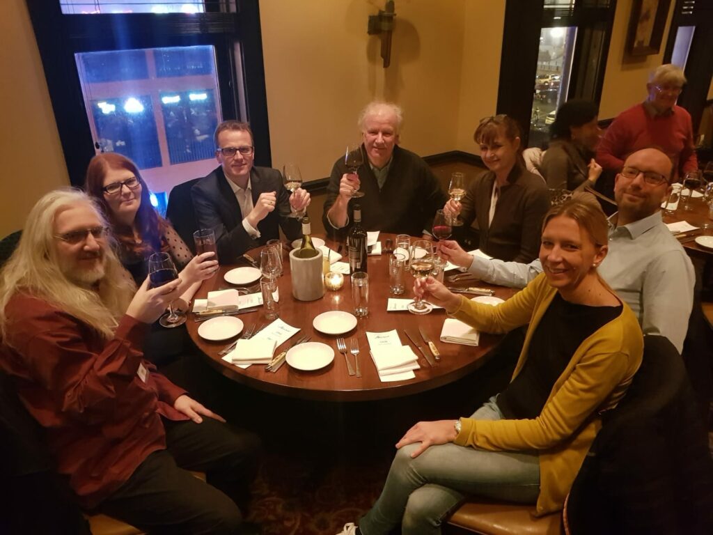 People sitting round a table in a bar having a drink