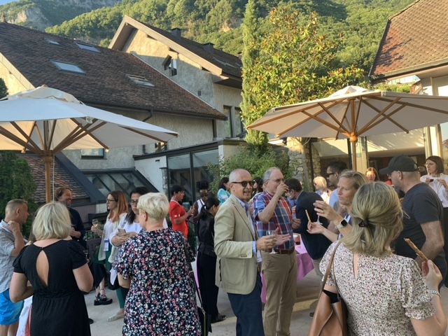 A group of attendees chat together on the terrace