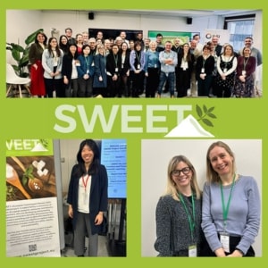 A group of people standing in front of a banner that says sweet.